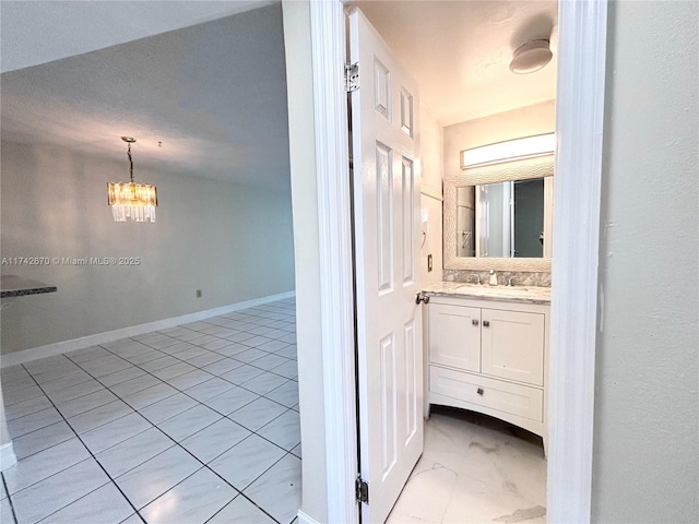 bathroom with vanity and a notable chandelier