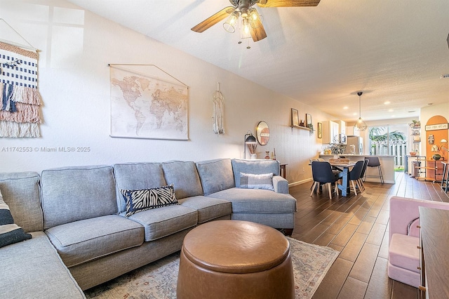 living room with wood-type flooring and ceiling fan