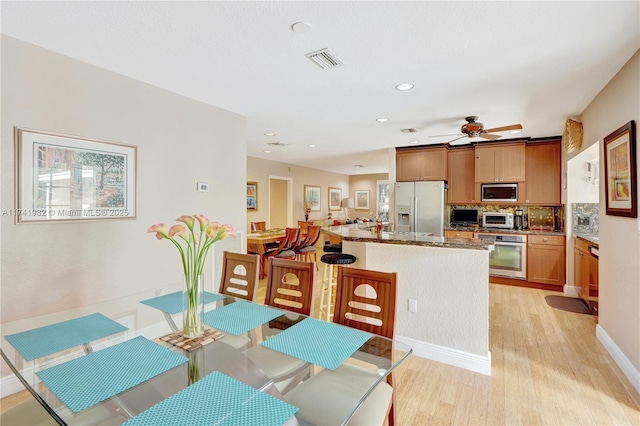 dining area featuring ceiling fan and light hardwood / wood-style floors