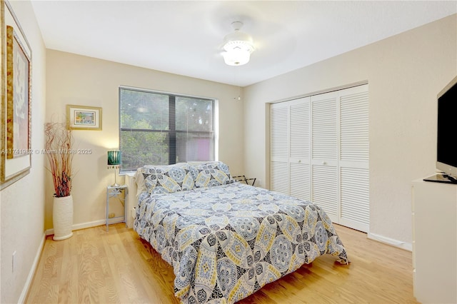 bedroom with light wood-type flooring and a closet