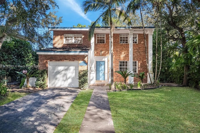 view of front of property featuring a garage and a front lawn