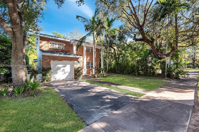 view of front of house featuring a garage and a front lawn