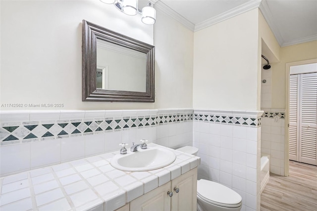 full bathroom with hardwood / wood-style flooring, vanity, ornamental molding, shower / washtub combination, and toilet