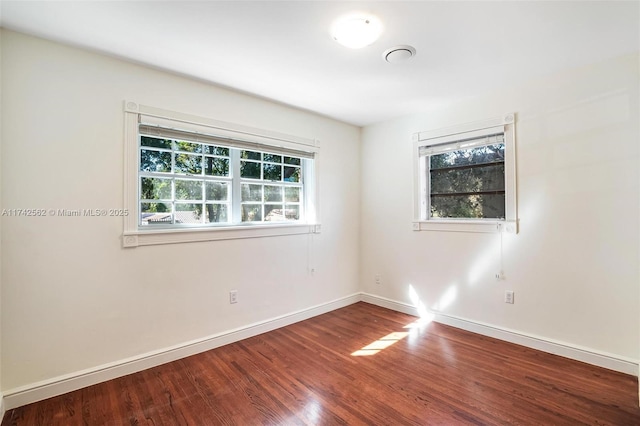 empty room featuring hardwood / wood-style floors and a wealth of natural light