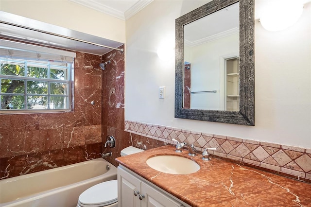 full bathroom with ornamental molding, tiled shower / bath, vanity, and toilet