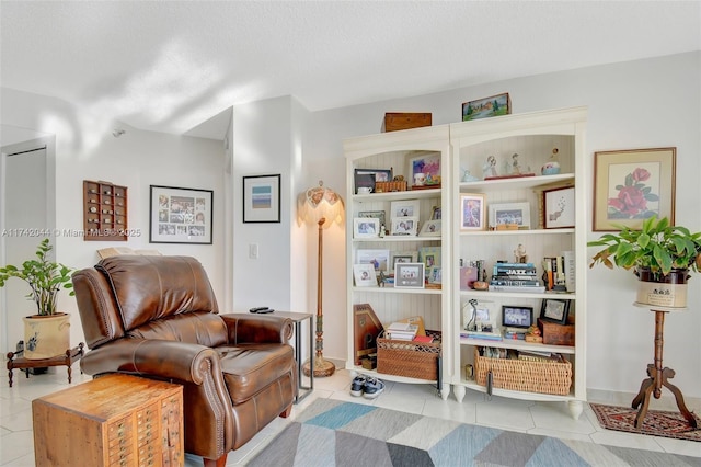 sitting room featuring light tile patterned floors and a textured ceiling