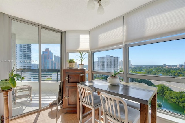 sunroom featuring a water view