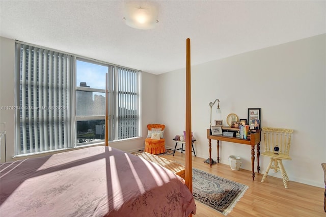 bedroom featuring hardwood / wood-style flooring and a textured ceiling