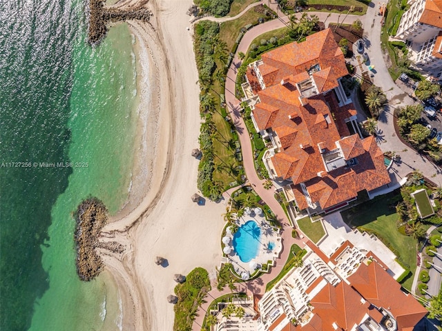 bird's eye view featuring a water view and a beach view