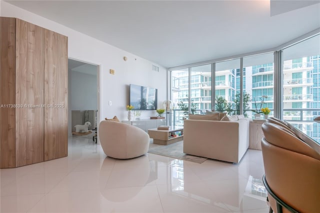 living room with expansive windows and light tile patterned flooring