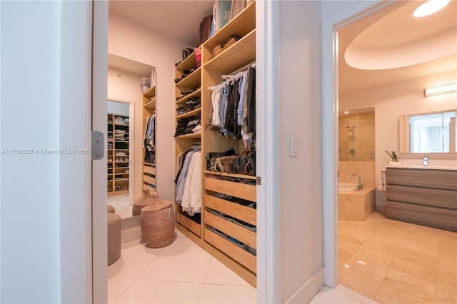 spacious closet featuring light tile patterned floors