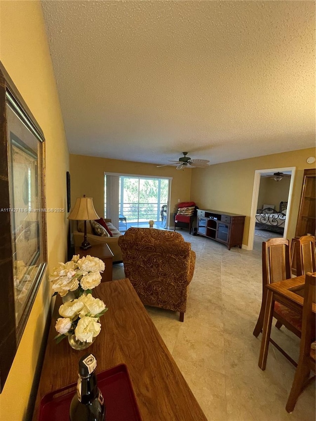 110 Lake Meryl Dr Unit 216, West Palm Beach, FL 33411 - living area featuring a ceiling fan and a textured ceiling