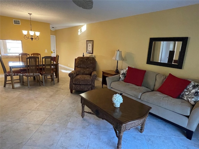 110 Lake Meryl Dr Unit 216, West Palm Beach, FL 33411 - living room featuring light tile patterned floors, visible vents, a chandelier, and baseboards