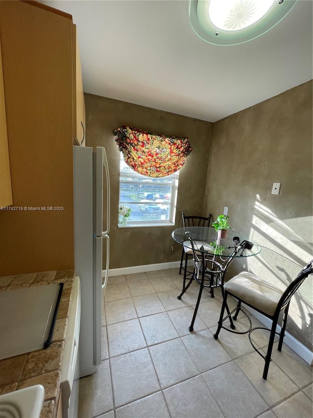 110 Lake Meryl Dr Unit 216, West Palm Beach, FL 33411 - dining space with baseboards and light tile patterned floors