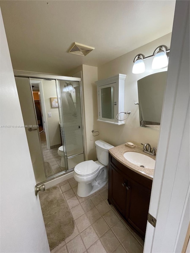 110 Lake Meryl Dr Unit 216, West Palm Beach, FL 33411 - bathroom featuring tile patterned flooring, a shower stall, toilet, vanity, and visible vents