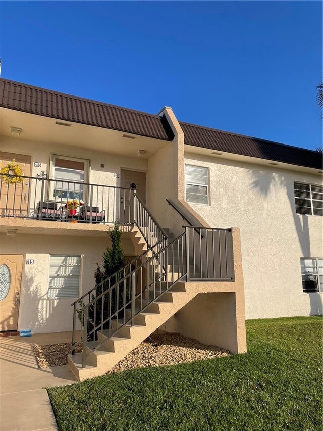 110 Lake Meryl Dr Unit 216, West Palm Beach, FL 33411 - entrance to property featuring a tile roof and stucco siding