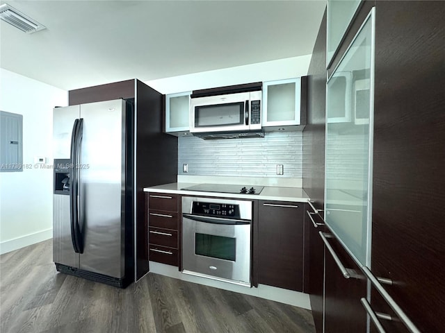 kitchen featuring dark hardwood / wood-style flooring, decorative backsplash, dark brown cabinets, and stainless steel appliances