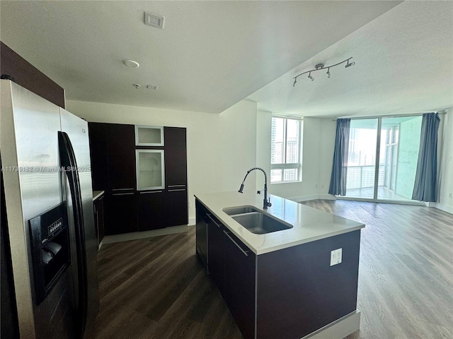 kitchen featuring stainless steel refrigerator with ice dispenser, wood-type flooring, sink, and an island with sink