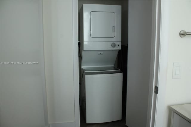 laundry room with stacked washer / drying machine