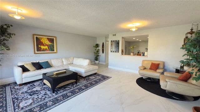 living area with visible vents, baseboards, a textured ceiling, and marble finish floor