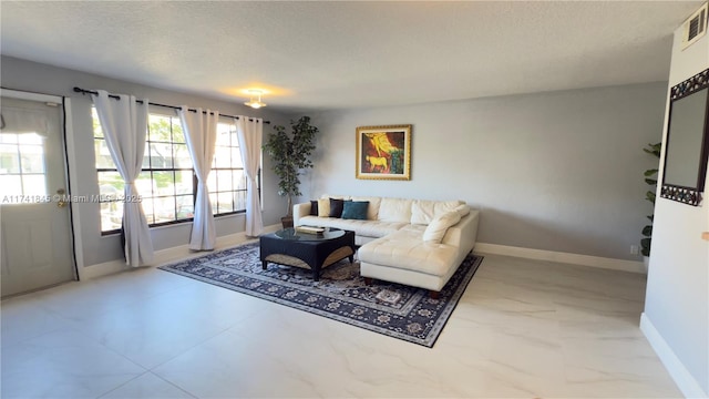 living room featuring visible vents, baseboards, a textured ceiling, and marble finish floor