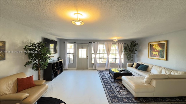 living area featuring tile patterned floors and a textured ceiling