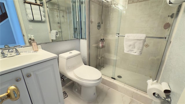 bathroom with vanity, a shower stall, and toilet