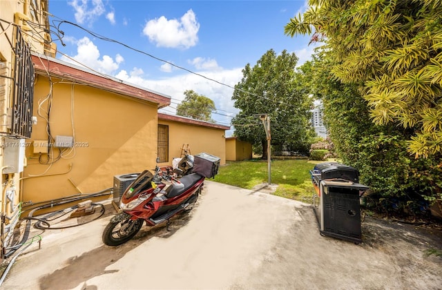 view of car parking featuring a lawn