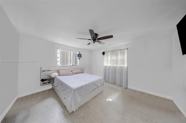 bedroom featuring ceiling fan and multiple windows