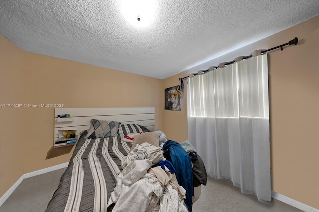 carpeted bedroom featuring a textured ceiling