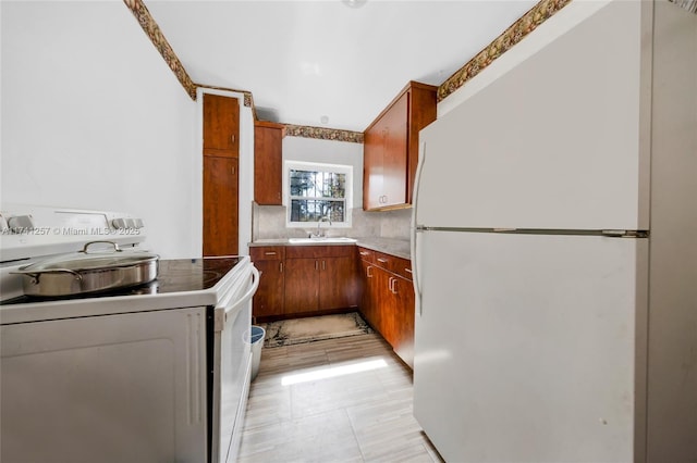 kitchen with sink, white appliances, and decorative backsplash