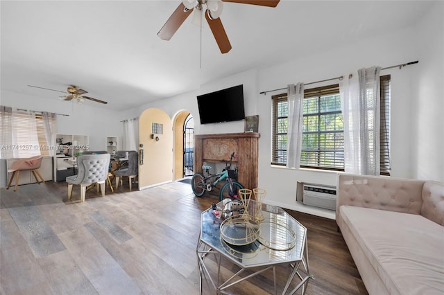 living room with hardwood / wood-style floors, a wall mounted AC, and ceiling fan