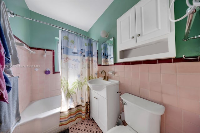 full bathroom with vanity, toilet, tile walls, and shower / bath combo