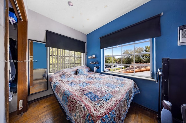 bedroom with dark wood-type flooring