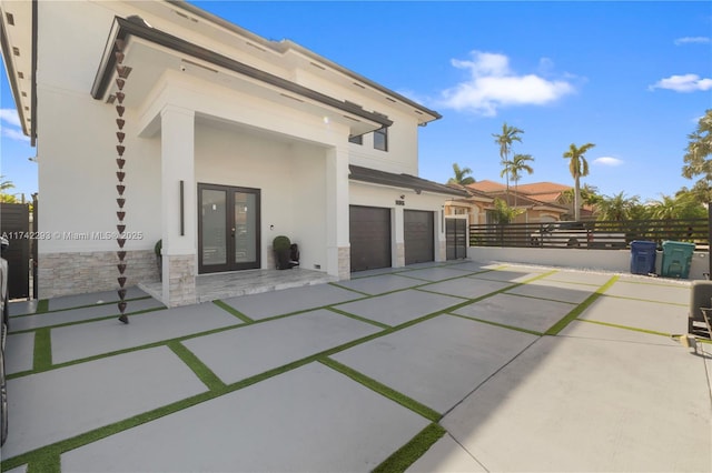 view of patio / terrace with a garage and french doors