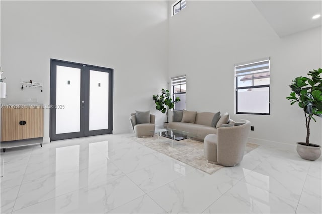 living room featuring french doors and a high ceiling