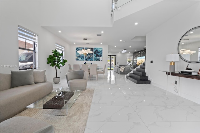 living room with a healthy amount of sunlight and a towering ceiling