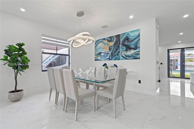 dining space with an inviting chandelier and french doors