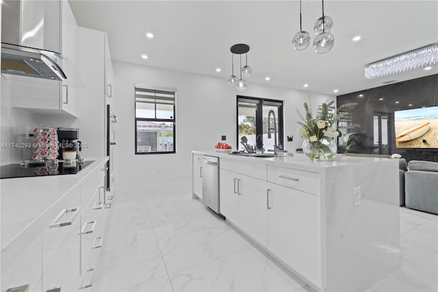 kitchen featuring pendant lighting, white cabinetry, sink, a center island with sink, and black electric cooktop