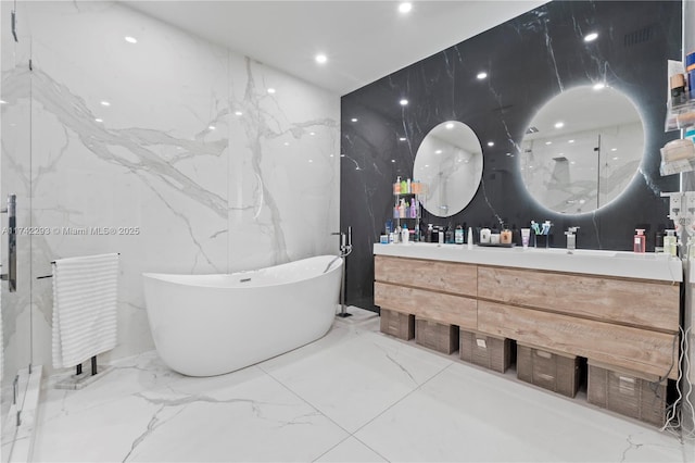 bathroom featuring vanity and a washtub