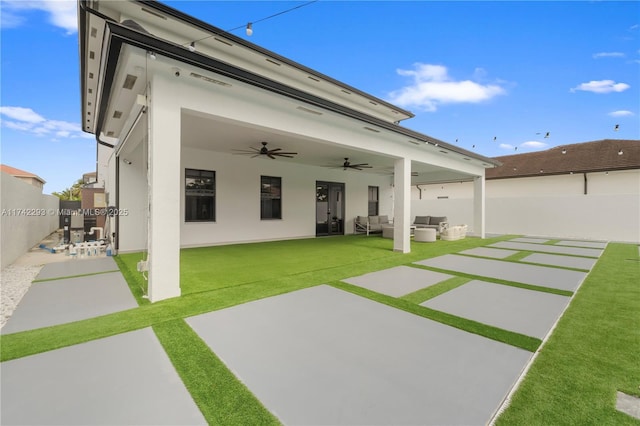 exterior space featuring ceiling fan, a yard, outdoor lounge area, and a patio area