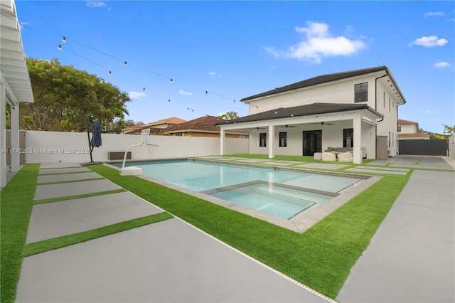 view of pool with an in ground hot tub, ceiling fan, and a patio area