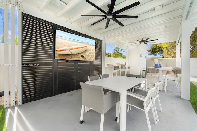 view of patio with area for grilling and ceiling fan