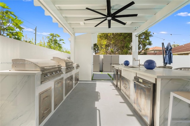 view of patio / terrace with ceiling fan, an outdoor kitchen, grilling area, and sink