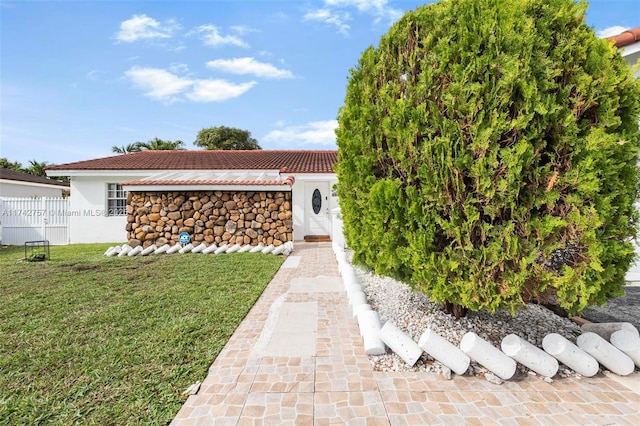 doorway to property with a yard