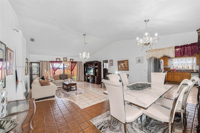 tiled dining room featuring lofted ceiling, sink, a textured ceiling, and a chandelier