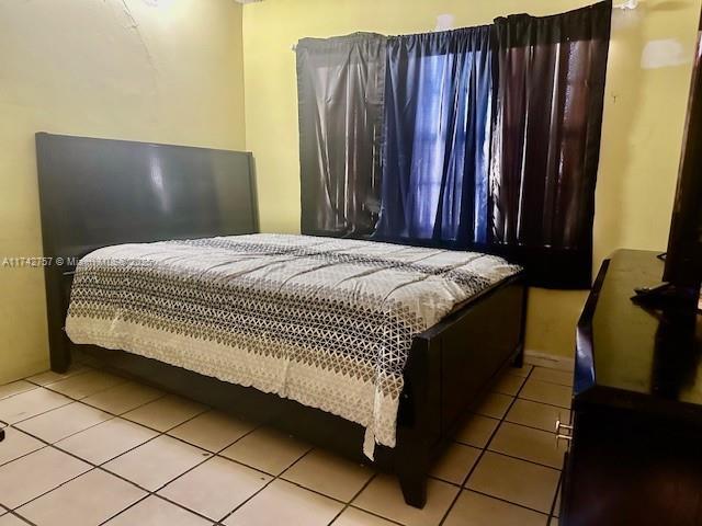 bedroom featuring light tile patterned floors