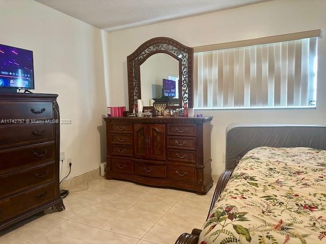 bedroom with light tile patterned floors