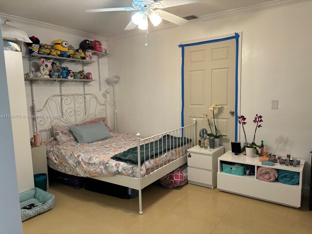 bedroom with crown molding, ceiling fan, and light tile patterned flooring