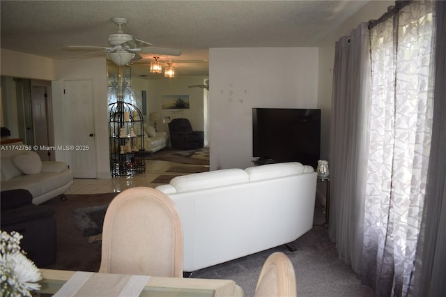 living area featuring a textured ceiling and a ceiling fan